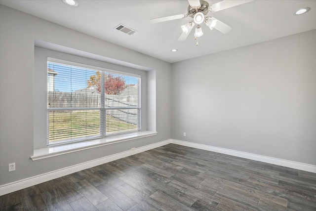 empty room featuring ceiling fan and dark hardwood / wood-style flooring