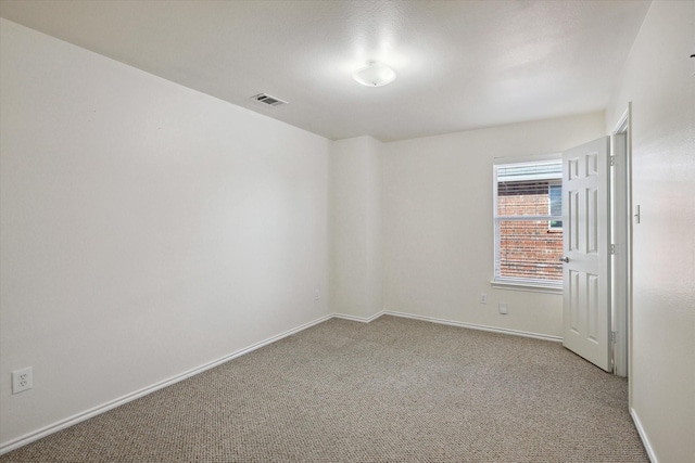 unfurnished room featuring light carpet