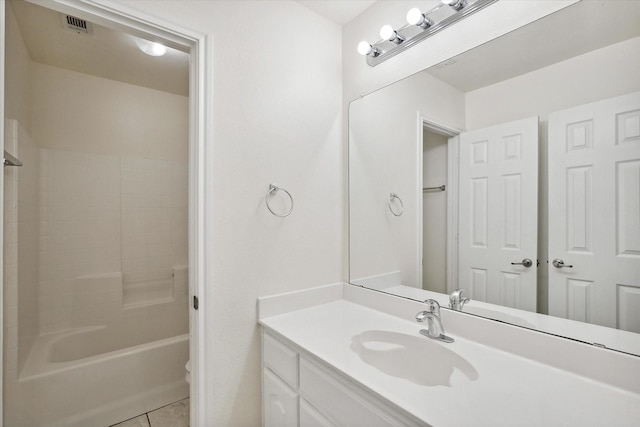 bathroom featuring tile patterned flooring, vanity, and shower / washtub combination