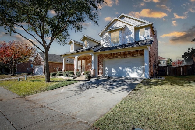 view of front of home featuring a porch, a garage, and a lawn