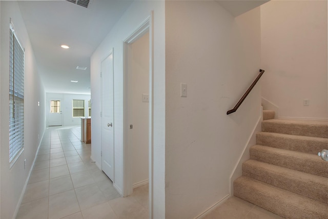 stairs featuring tile patterned floors