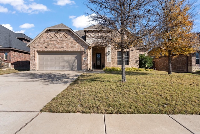 french country style house with an attached garage, driveway, a front yard, and brick siding