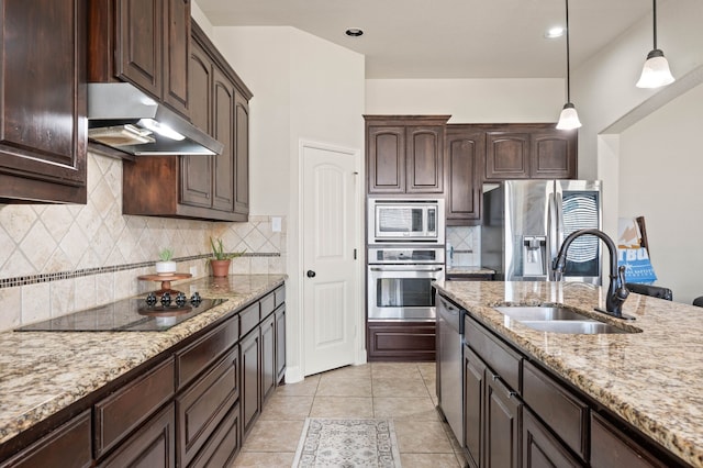 kitchen featuring dark brown cabinetry, under cabinet range hood, a sink, appliances with stainless steel finishes, and pendant lighting