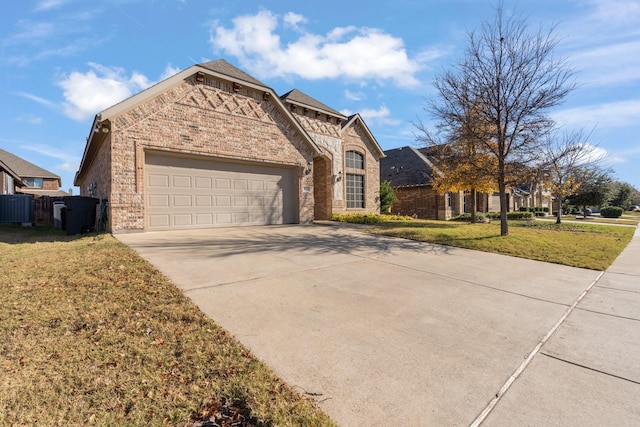 view of front of house featuring a garage, central air condition unit, and a front lawn