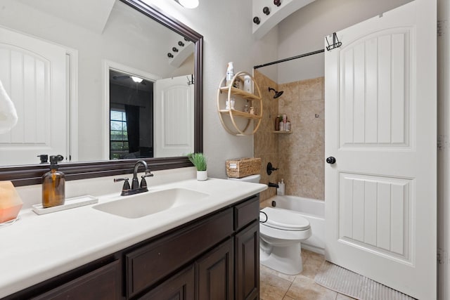 full bathroom with vanity, toilet, tiled shower / bath combo, and tile patterned flooring