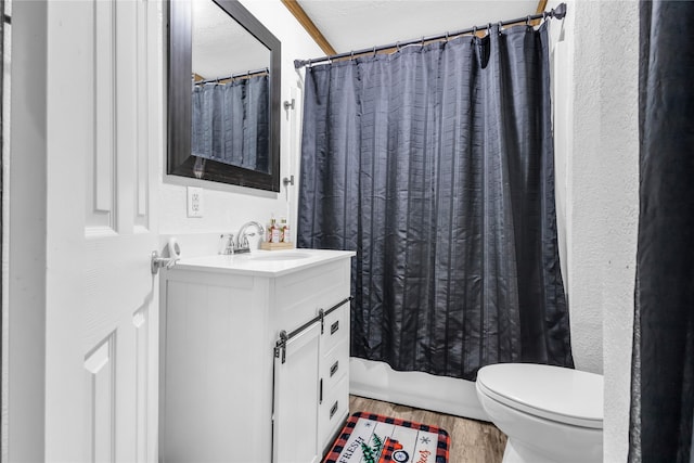 full bathroom with shower / bathtub combination with curtain, vanity, toilet, and wood-type flooring