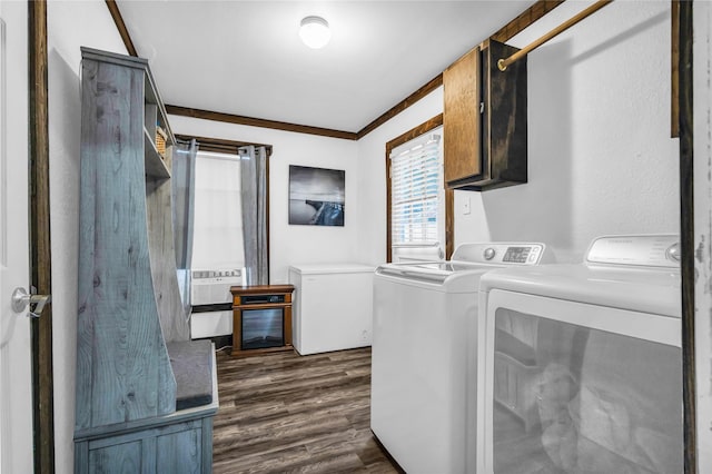 clothes washing area featuring cabinets, dark wood-type flooring, cooling unit, washer and clothes dryer, and ornamental molding