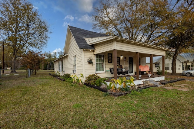 view of front of property with a porch and a front lawn