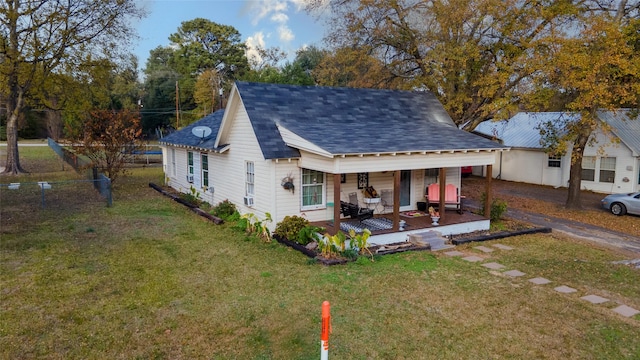 back of property with a porch and a yard