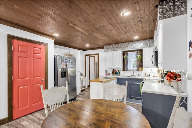 kitchen featuring white cabinetry, sink, stainless steel appliances, wood ceiling, and hardwood / wood-style flooring