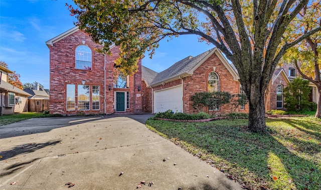 view of property with a garage and a front lawn