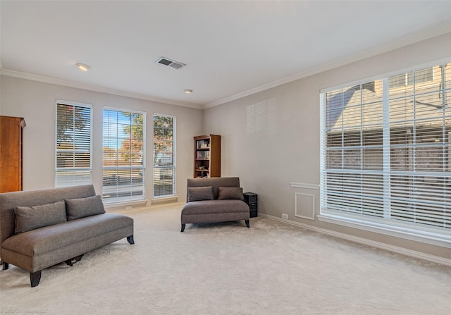 living area featuring ornamental molding and light carpet