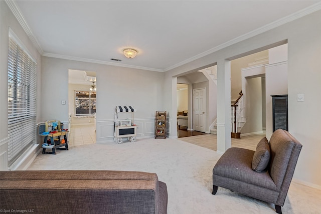 living room featuring crown molding and light carpet