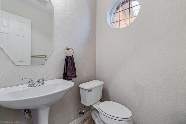 bathroom with toilet and sink