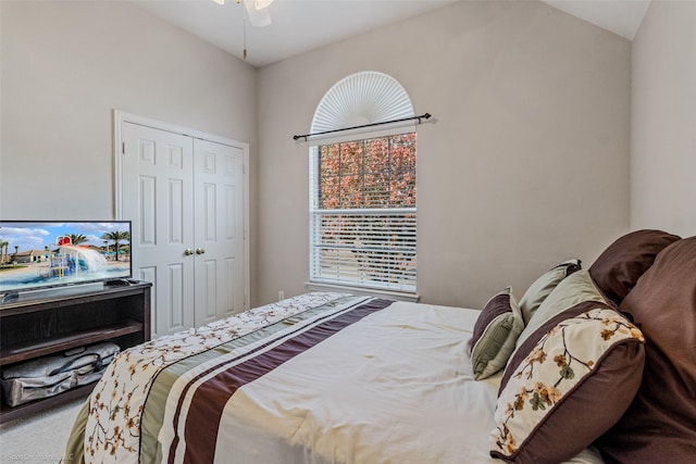 carpeted bedroom featuring a closet, ceiling fan, and lofted ceiling