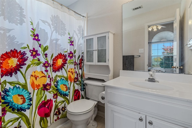 bathroom with tile patterned floors, vanity, curtained shower, and toilet