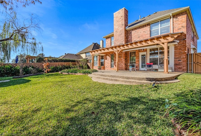 back of property featuring a yard and a patio