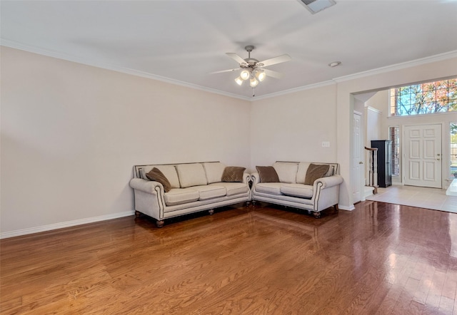 living room with light hardwood / wood-style flooring, ceiling fan, and ornamental molding