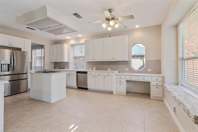 kitchen featuring a healthy amount of sunlight, white cabinetry, and appliances with stainless steel finishes