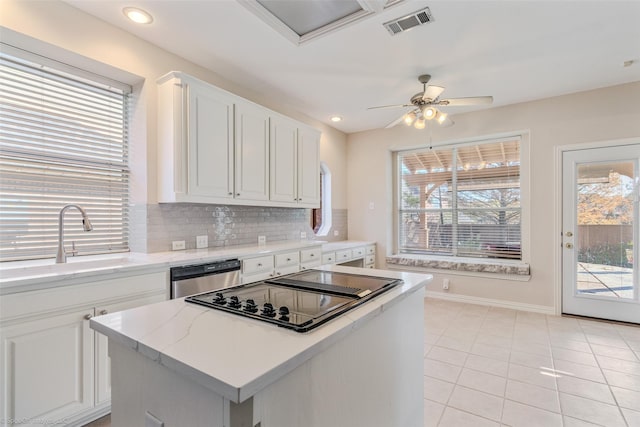 kitchen featuring dishwasher, plenty of natural light, and sink