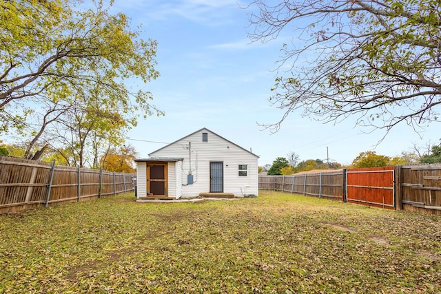 back of property with a lawn