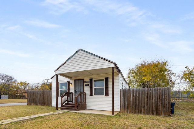 bungalow-style house with a front lawn