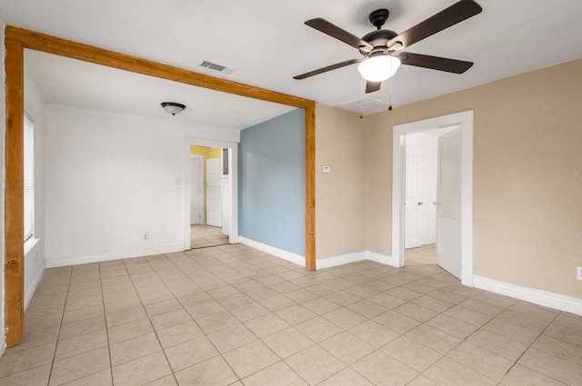 empty room featuring ceiling fan and light tile patterned floors