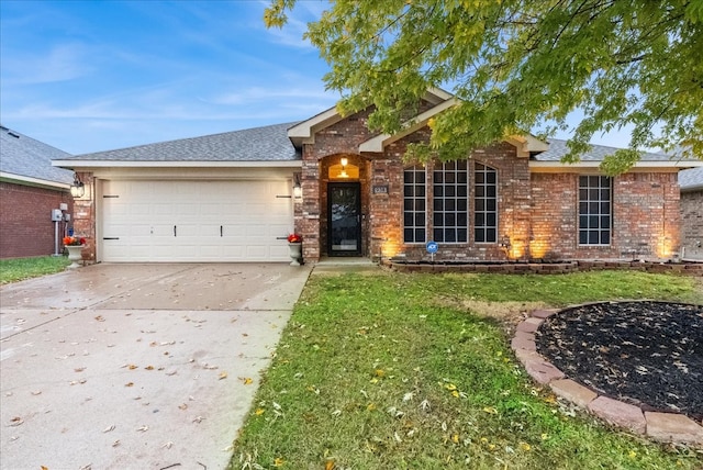 ranch-style home featuring brick siding, a shingled roof, an attached garage, driveway, and a front lawn