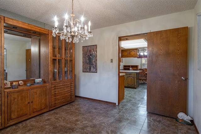 dining room featuring a textured ceiling and an inviting chandelier