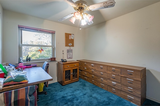 office space with ceiling fan and dark colored carpet