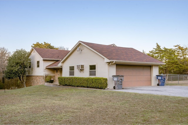 ranch-style home with a front lawn and a garage