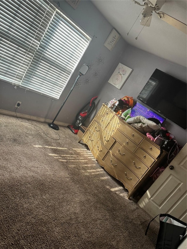 unfurnished bedroom featuring ceiling fan, carpet floors, and lofted ceiling