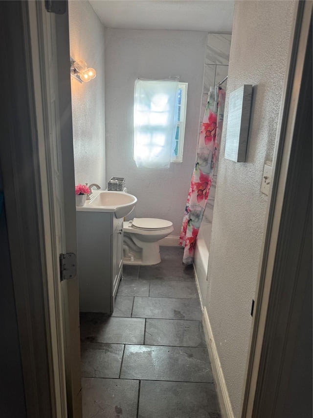 full bathroom featuring vanity, shower / tub combo, and toilet