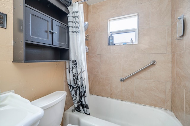 bathroom with shower / tub combo and toilet