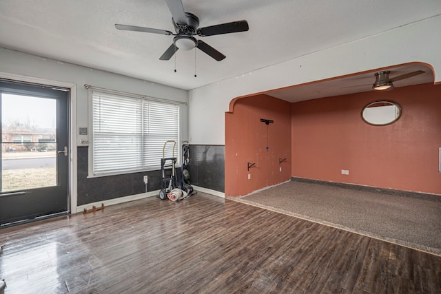 unfurnished room with ceiling fan, wood-type flooring, and a textured ceiling