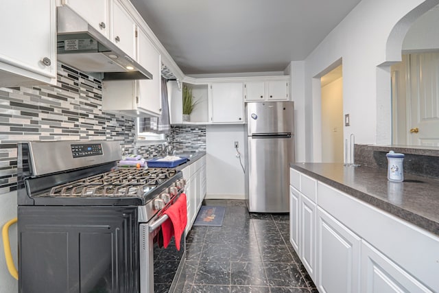 kitchen featuring stainless steel appliances, white cabinetry, sink, and decorative backsplash