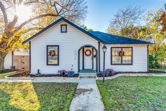 bungalow-style home with a front lawn