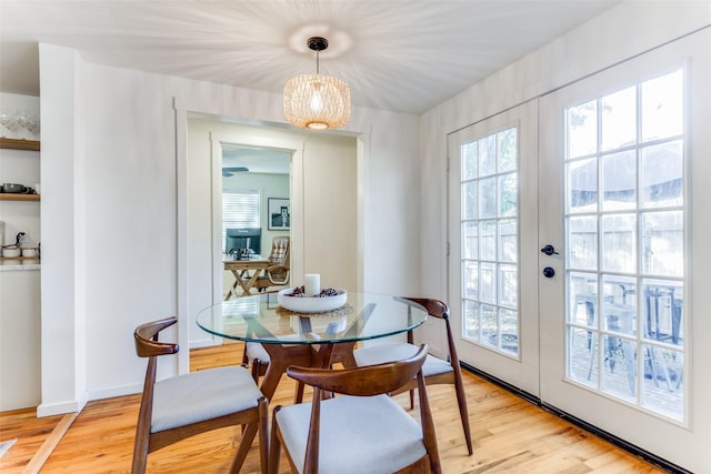 dining area featuring french doors and light hardwood / wood-style flooring