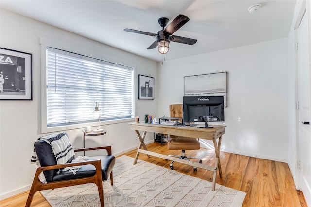 office with ceiling fan and light wood-type flooring