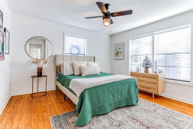 bedroom with hardwood / wood-style floors and ceiling fan