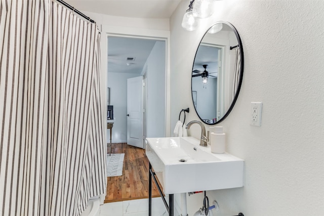 bathroom featuring wood-type flooring, ceiling fan, and sink