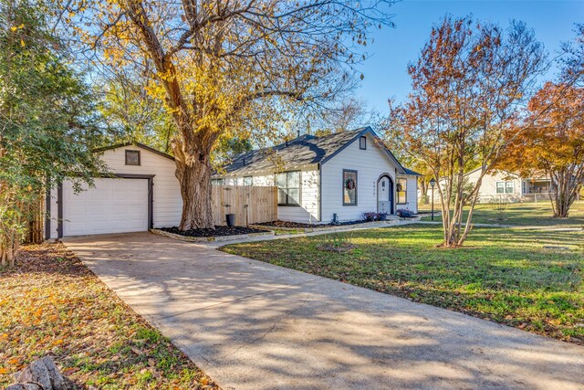 view of front facade featuring a garage, an outdoor structure, and a front yard