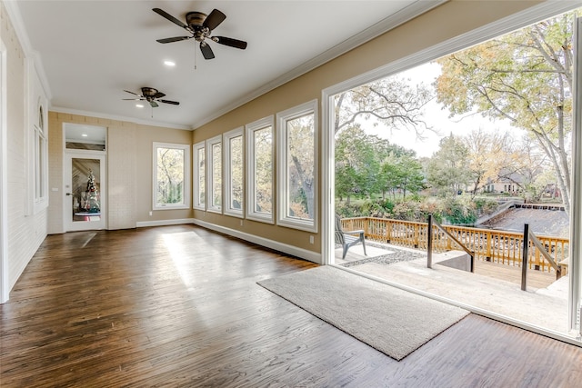 sunroom / solarium featuring ceiling fan