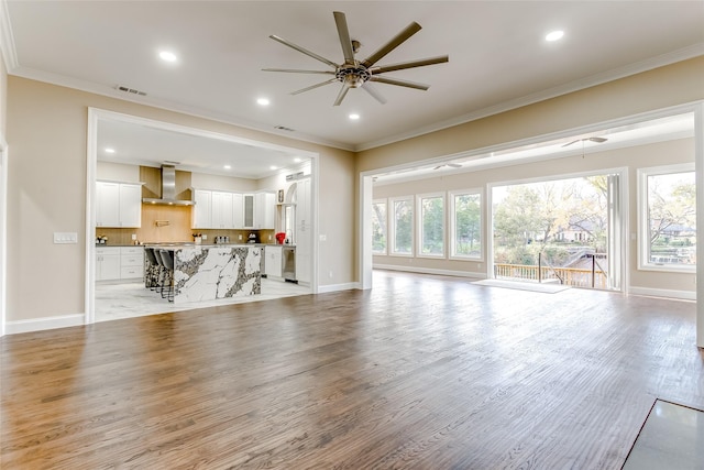 unfurnished living room with light hardwood / wood-style floors, plenty of natural light, and ceiling fan