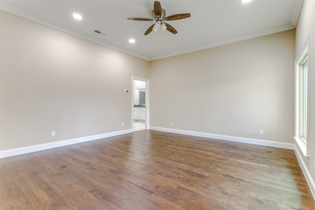 unfurnished room featuring hardwood / wood-style flooring, ceiling fan, and crown molding