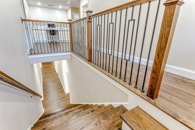 stairs featuring wood-type flooring