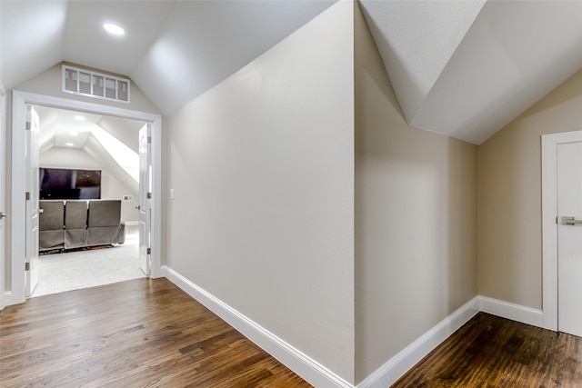 interior space with hardwood / wood-style flooring and lofted ceiling