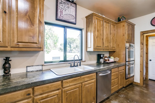 kitchen with dark stone countertops, sink, and appliances with stainless steel finishes