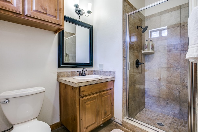 bathroom with an enclosed shower, vanity, and toilet