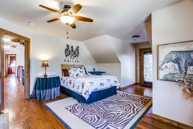 bedroom featuring ceiling fan, lofted ceiling, and dark wood-type flooring